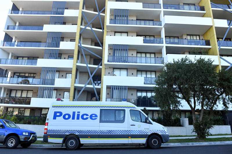 Police vans are seen at a lock downed apartment building at Warby Street in the south western suburb of Campbelltown in Sydney.