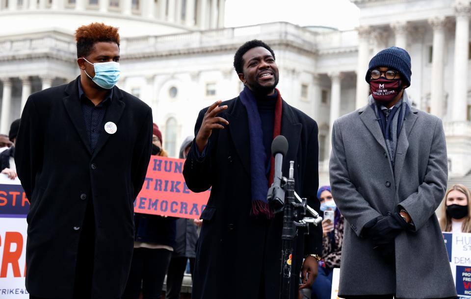 Rev. Stephen A. Green (center), chair of Faith for Black Lives, and other activists talk to reporters Jan. 13, 2022 in front of the U.S. Capitol about the need for federal voting rights legislation.