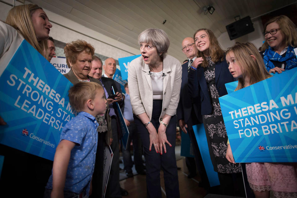 <p>Britain’s Prime Minister, Theresa May, center, speaks to supporters and their children at Thornhill Cricket and Bowling Club in Dewsbury, England, during a general election campaign visit to West Yorkshire, Saturday June 3, 2017. (Photo: Stefan Rousseau/PA via AP) </p>