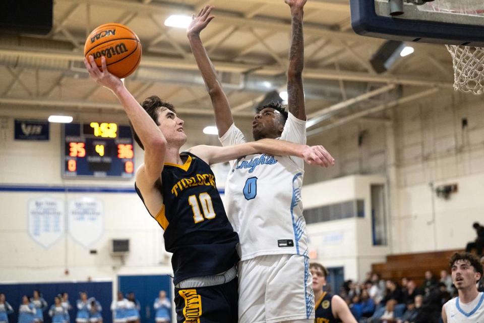 Turlock’s Andrew Johnson scores over Downey’s Reuben Lewis in the Central California Athletic League game at Downey High School in Modesto, Calif., Friday, Jan. 19, 2024.