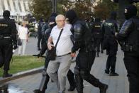Police detain a man during a protest following presidential elections in Minsk, Belarus, Monday, Aug. 10, 2020. Thousands of people have protested in Belarus for a second straight night after official results from weekend elections gave an overwhelming victory to authoritarian President Alexander Lukashenko, extending his 26-year rule. A heavy police contingent blocked central squares and avenues, moving quickly to disperse protesters and detained dozens. (AP Photo/Sergei Grits)