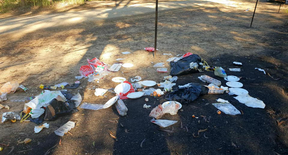 Garbage bags, paper plates, egg cartons and other scraps are seen at Noosa North Shore Beach Campground. A woman has blamed the garbage on tourists not cleaning up after themselves.