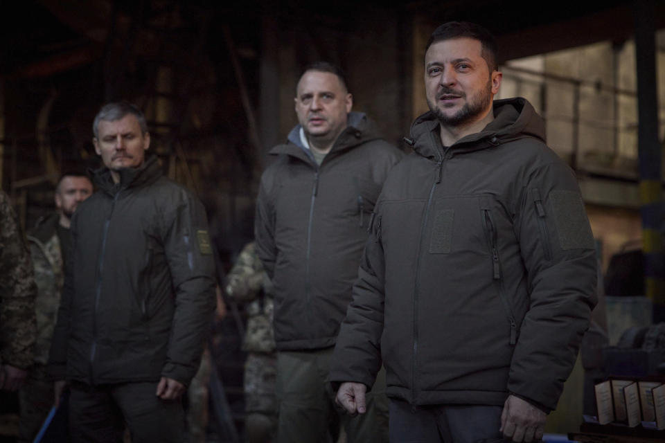 In this photo provided by the Ukrainian Presidential Press Office, Ukrainian President Volodymyr Zelenskyy, right, speaks to soldiers at the site of the heaviest battles with the Russian invaders in Bakhmut, Ukraine, Tuesday, Dec. 20, 2022. (Ukrainian Presidential Press Office via AP)