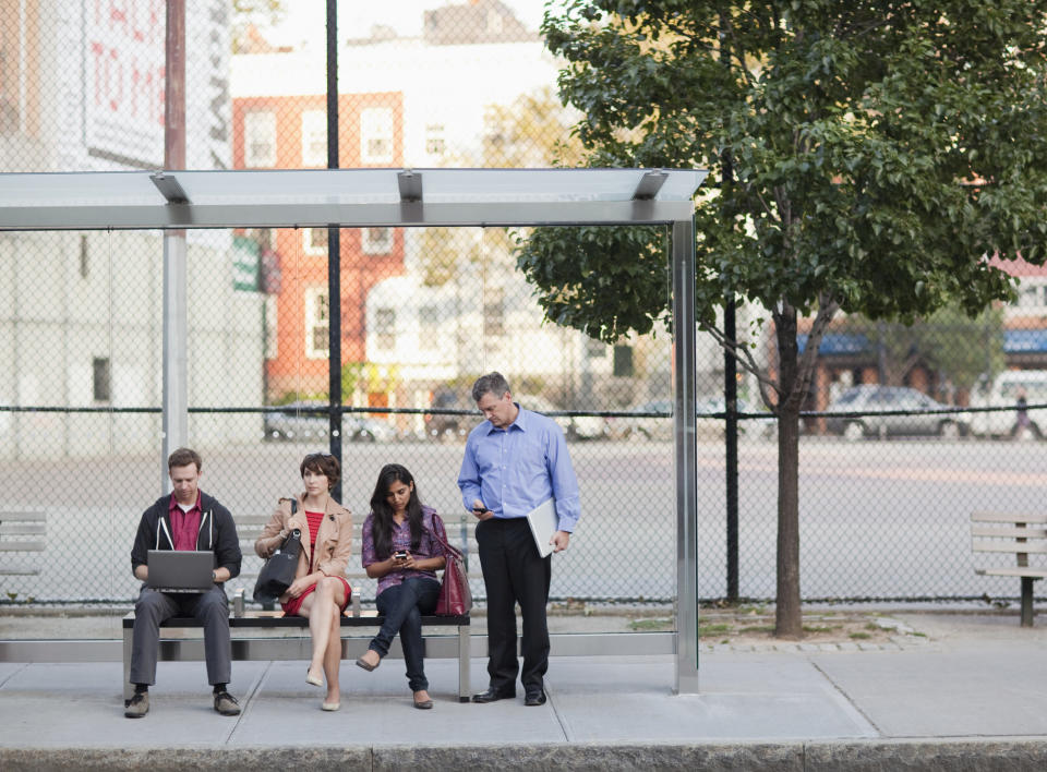 people waiting at a bus stop