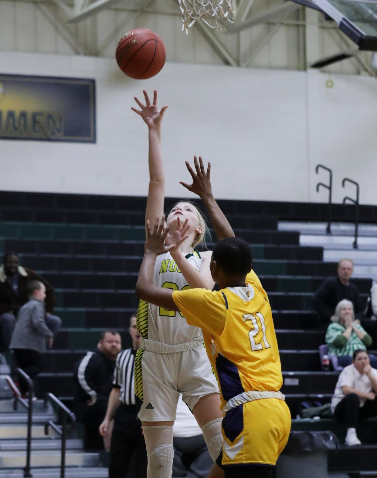 North Bullitt's Kylie Downey (20) shoots a layup against Shawnee's Tamiah Wadlington (21) during the opening round of the Girls LIT at the North Bullitt High School in Shepherdsville, Ky. on Jan. 23, 2023.