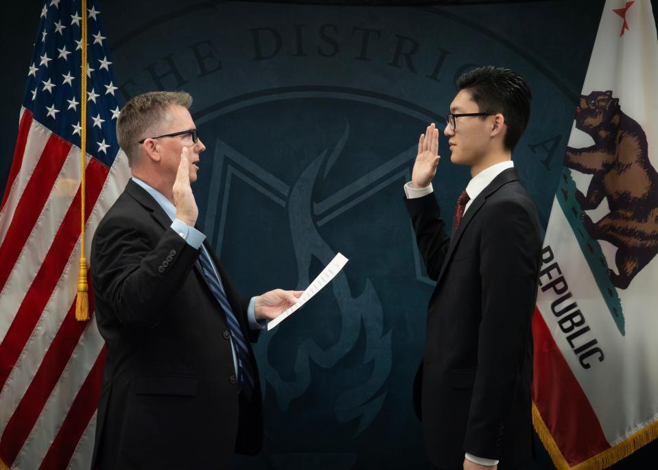 Peter Park (at right) recently made history for being the youngest person to pass the state bar exam in California. Park, a former law clerk with the Tulare County District Attorney's office, passed the test at age 17 after taking it in July 2023. Park is pictured being sworn in in December 2023 by Tim Ward.