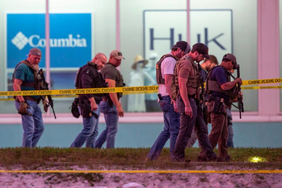 Law enforcement officers canvas the ground looking for evidence outside Surf Style in Biloxi after a chaotic shooting during Black Spring Break that left one police officer injured on Sunday, April 16, 2023.