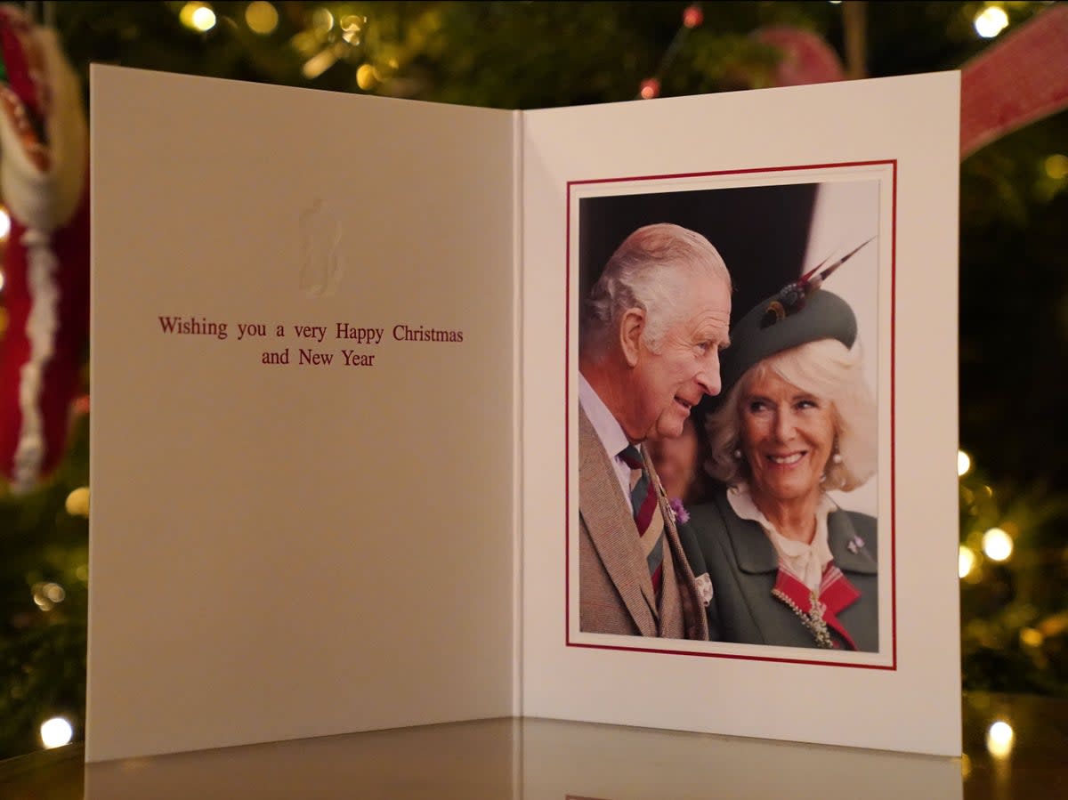 The 2022 Christmas card of King Charles III and Camilla, Queen Consort in front of a Christmas tree in Clarence House, on December 11, 2022 (Buckingham Palace via Getty Imag)