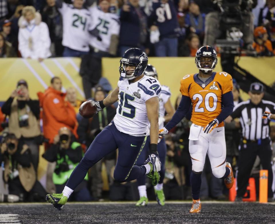 Seattle Seahawks' Jermaine Kearse (15) scores on a 23-yard touchdown reception in front of Denver Broncos' Mike Adams (20) during the second half of the NFL Super Bowl XLVIII football game Sunday, Feb. 2, 2014, in East Rutherford, N.J. (AP Photo/Matt Slocum)