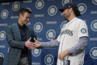 Jerry Dipoto, left, Seattle Mariners President of Baseball Operations, shakes hands with new Seattle Mariners pitcher Robbie Ray, right, Wednesday, Dec. 1, 2021, during a news conference in Seattle. The AL Cy Young Award winner — who previously pitched for the Toronto Blue Jays — signed a five-year contract with the Mariners. (AP Photo/Ted S. Warren)