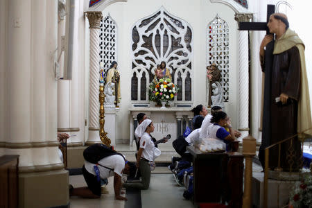 A group of youth pilgrims pray inside a church, ahead of Pope Francis' visit in Panama City, Panama January 21, 2019. REUTERS/Carlos Jasso