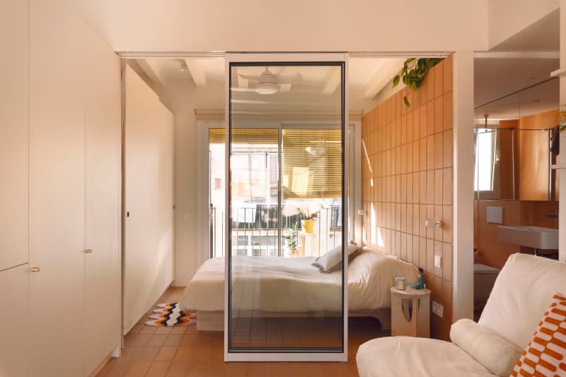 Glass door into studio apartment bedroom.