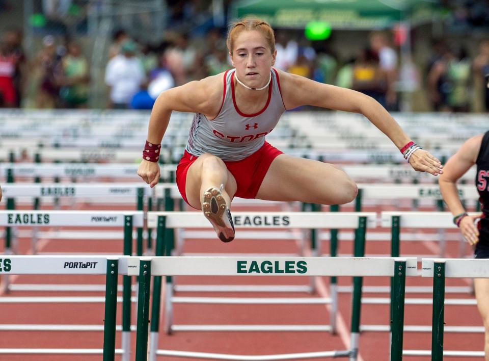 Victory Christian's Amber Choquette leaps over the last hurdle en route to winning the 100 hurdles on Thursday at the Class 1A, Districtd 10 track and field meet at George Jenkins High School.