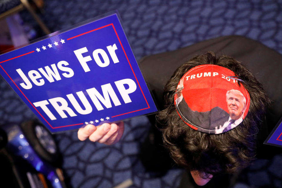 <p>Wearing a Trump yarmulke, an attendee holds a sign supporting Trump at the Conservative Political Action Conference (CPAC) in Oxen Hill, Md., Feb. 22, 2018. (Photo: Kevin Lamarque/Reuters) </p>