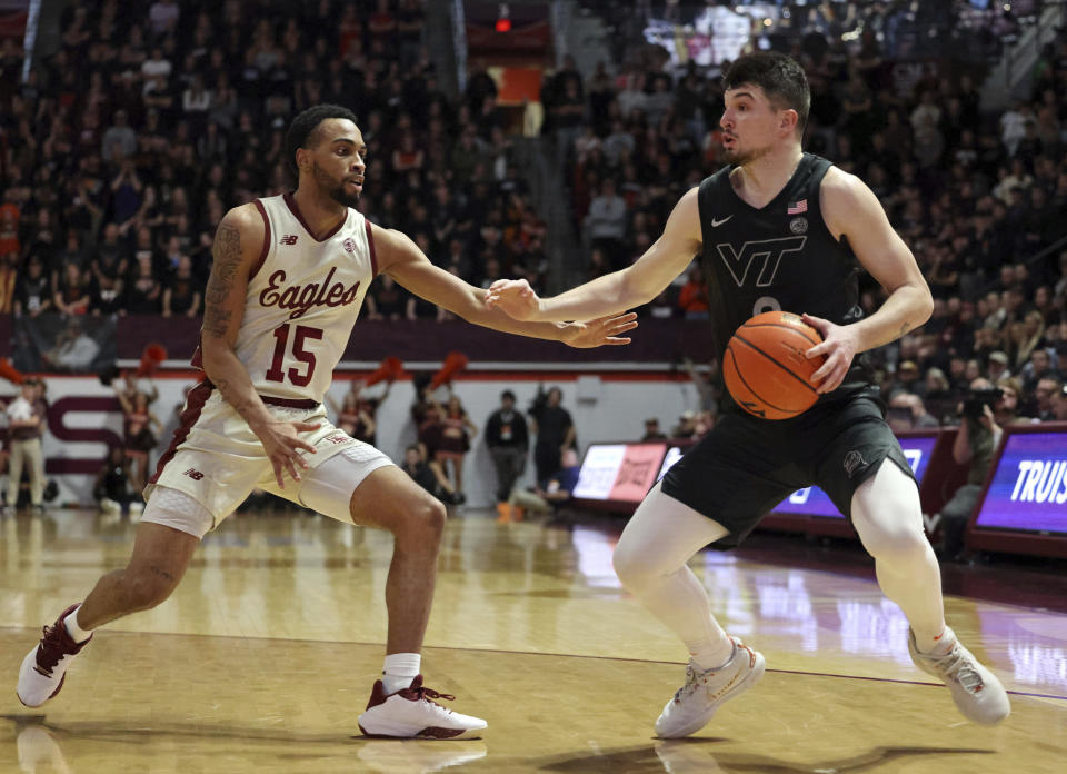 Boston College's Jack Di Donna (15) defends against Virginia Tech's Hunter Cattoor (0) during the second half of an NCAA college basketball game Tuesday, Jan. 23, 2024, in Blacksburg, Va. (Matt Gentry/The Roanoke Times via AP)