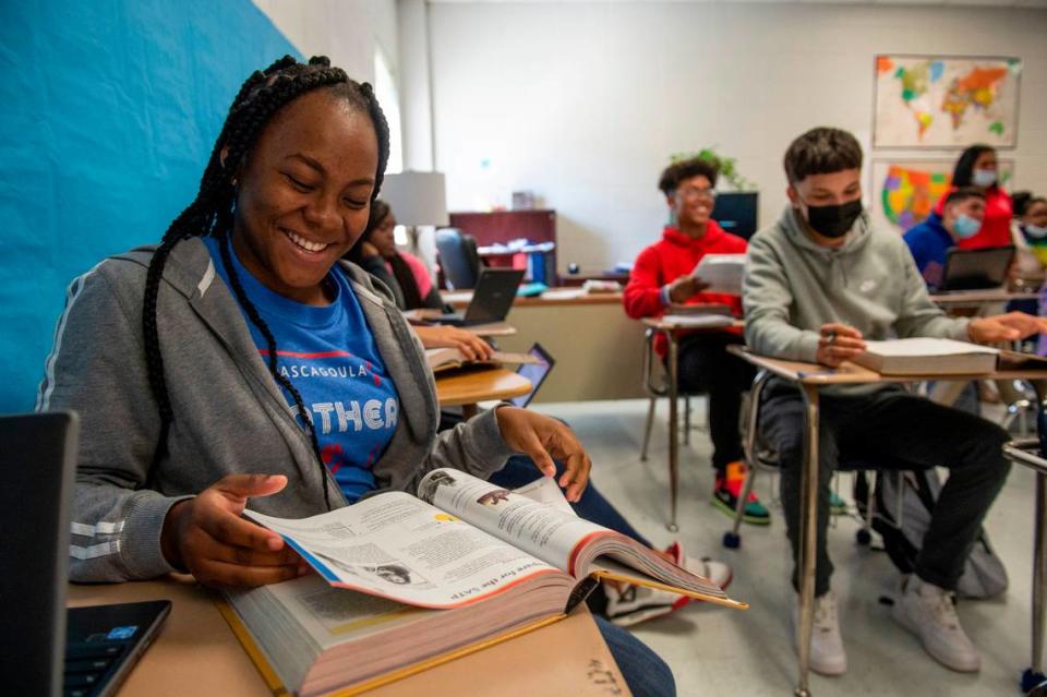 Camelee Smith, left, looks at her textbook during class at Pascagoula High School in Pascagoula on Monday, Oct. 25, 2021.