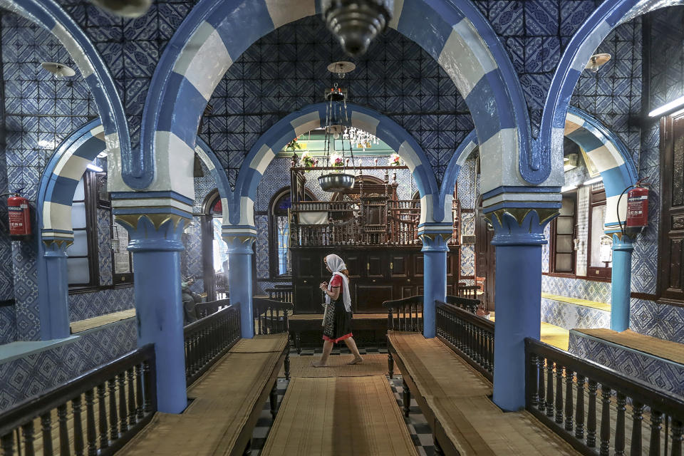 FILE - A tourist visits La Ghriba, the oldest synagogue in Africa, on the Island of Djerba, southern Tunisia, Oct. 28, 2015. The Tunisian Interior Ministry says a naval guard shot and killed a colleague and two civilians Tuesday, May 9, 2023, near the synagogue during an annual Jewish pilgrimage. (AP Photo/Mosa'ab Elshamy, File)