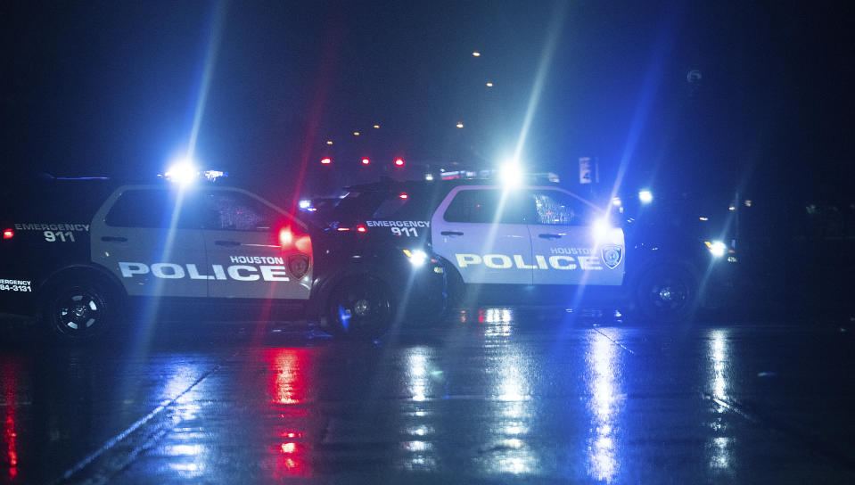 Houston Police cars block access to Main Street near Sam Houston Parkway after a shooting outside Cole's Antique Village and Flea Market, Sunday, Nov. 12, 2023, in Pearland, Texas, near Houston. (Elizabeth Conley/Houston Chronicle via AP)