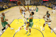 CORRECTS TO GAME 2 INSTEAD OF GAME 1 - Golden State Warriors guard Stephen Curry, middle left, shoots against Boston Celtics forward Jayson Tatum during the first half of Game 2 of basketball's NBA Finals in San Francisco, Sunday, June 5, 2022. (Kyle Terada/Pool Photo via AP)