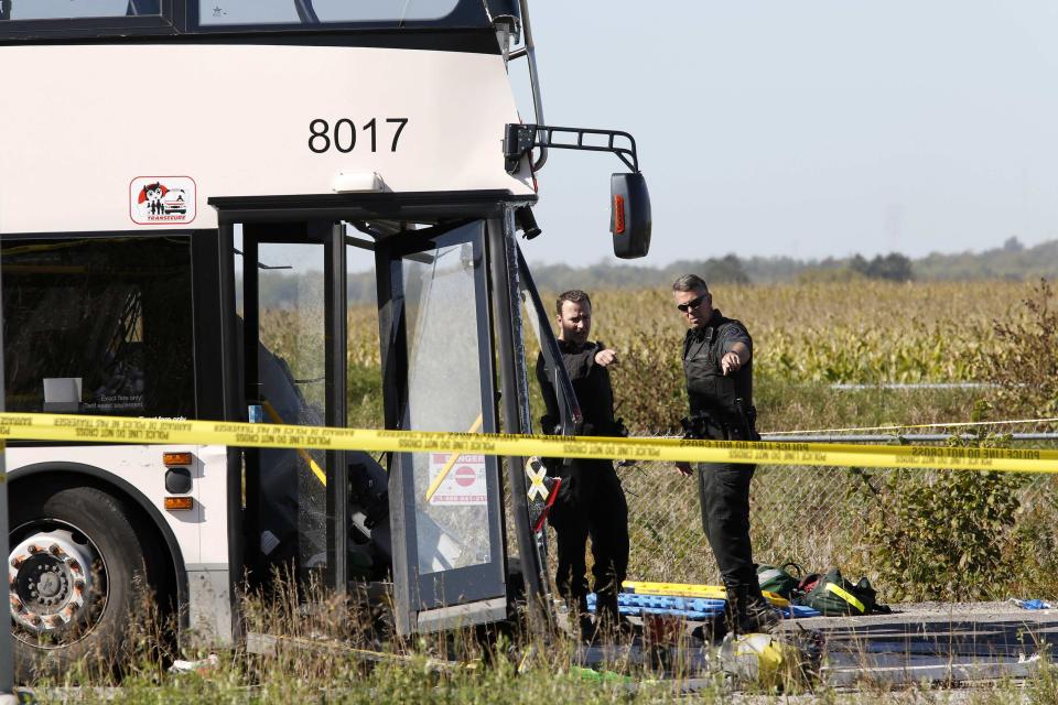 Police examine the scene of an accident involving a bus and a train in Ottawa