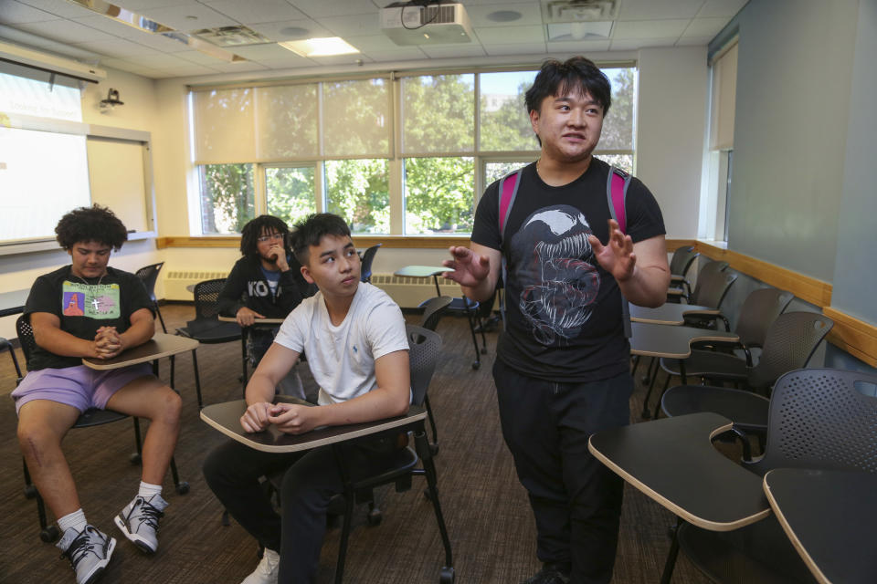 Kevin Tran, 16, right, speaks about the Bridge to Calculus summer program at Northeastern University in Boston on Tuesday, Aug. 1, 2023. Like a lot of high school students, Tran loves superheroes, though perhaps for different reasons than his classmates. “They’re all insanely smart. In their regular jobs they’re engineers, they’re scientists,” he says. “And you can’t do any of those things without math.” (AP Photo/Reba Saldanha)