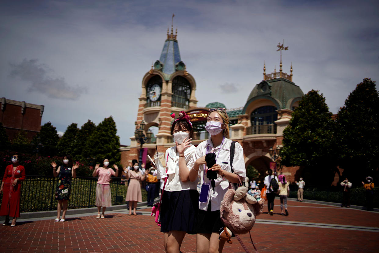 People wearing face masks visit the Shanghai Disney Resort, as the Shanghai Disneyland theme park reopens after being shut for the coronavirus disease (COVID-19) outbreak, in Shanghai, China June 30, 2022. REUTERS/Aly Song