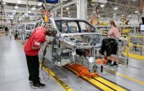 Stellantis assembly workers work on assembling the 2021 Jeep Grand Cherokee L