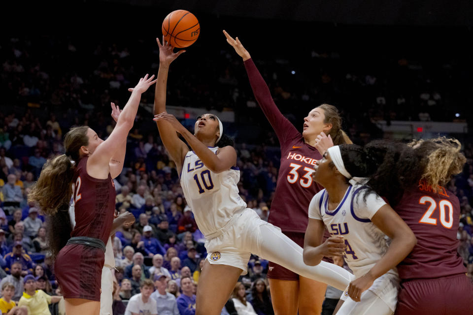 Nov 30, 2023; Baton Rouge, Louisiana, USA; LSU Lady Tigers forward Angel Reese (10) shoots against Virginia Tech Hokies guard Cayla King (22) and Virginia Tech Hokies center Elizabeth Kitley (33) during the first half at Pete Maravich Assembly Center. Mandatory Credit: Matthew Hinton-USA TODAY Sports