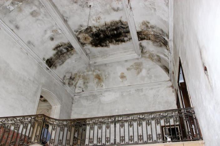<p>Before: the main vestibule. After consolidation, the restoration team began work on replacing the central vestibule. Extensive water damage forced this project to take priority. This photo was taken during the Waters family’s first visit to the property. Over the next few years of negotiating the contract, the ceiling completely fell in.</p>