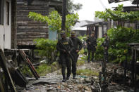 Police patrol a neighborhood abandoned by residents due to fear of criminal gangs in Buenaventura, Colombia, Thursday, Aug. 17, 2023. The Colombian government was hailed for signing a peace pact in 2016 with the country’s most powerful guerrilla force, the FARC, but authorities failed to carry out the agreement and seize control of the guerrilla's territories and mafias warred to take their place. (AP Photo/Fernando Vergara)