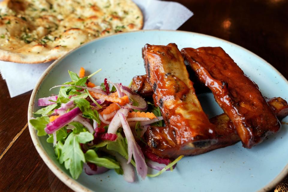 Smoked Barbecue Spareribs, shown here with Garlic Naan, is made with a sauce that uses an iconic Indian dark rum.