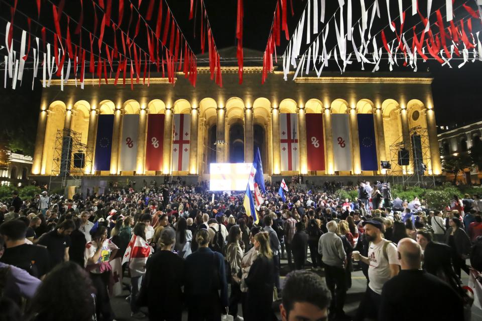 Demonstrators gather at the Parliamentary building during an opposition protest against the foreign influence bill in Tbilisi, Georgia, Tuesday, May 28, 2024. The Georgian parliament has overridden a presidential veto of the "foreign agents" legislation that has fueled Western concerns and sparked massive protests for weeks. (AP Photo/Zurab Tsertsvadze)