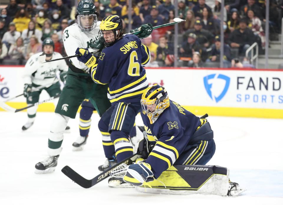 Michigan goaltender Erik Portillo (1) makes a save against Michigan State during first period action on Saturday, Feb. 12, 2022, at Little Caesars Arena in Detroit.