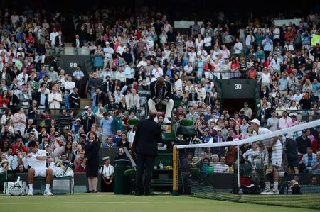 Tennis - Wimbledon - All England Lawn Tennis & Croquet Club, Wimbledon, England - 6/7/15 Men's Singles - Umpire Carlos Bernardes suspends play of the match between Serbia's Novak Djokovic and South Africa's Kevin Anderson until tomorrow due to bad light Mandatory Credit: Action Images / Tony O'Brien Livepic EDITORIAL USE ONLY.