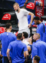 Dallas Mavericks forward Kristaps Porzingis, top, looks on from the bench during the second half of an NBA basketball game against the Cleveland Cavaliers, Friday, May 7, 2021, in Dallas. (AP Photo/Brandon Wade)