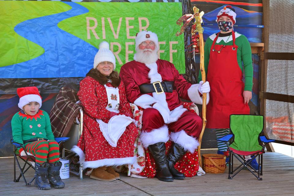Santa and Mrs. Claus, as portrayed by Barney and Eileen Combs, held a fundraiser Saturday at Cooper's Landing in support of Missouri River Relief as part of the CoMoGives Campaign. They are joined by their elves, grandchildren Wyatt and Lucas.