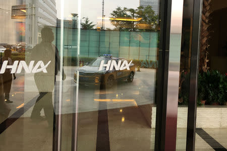 The HNA Group logo is seen on the gate of HNA Plaza building in Beijing, China July 4, 2018. REUTERS/Elias Glenn