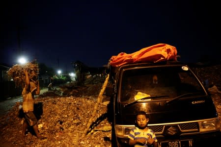 The Wider Image: Cash for trash: Indonesia village banks on waste recycling