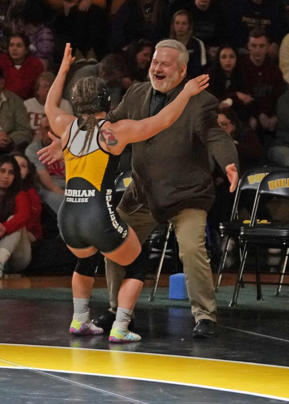 Adrian College's Zoe Nowicki celebrates with head coach Cliff Cushard after winning the national title at 136 pounds at the Cliff Keen National Collegiate Women's Wrestling Championships at Adrian College on Saturday.