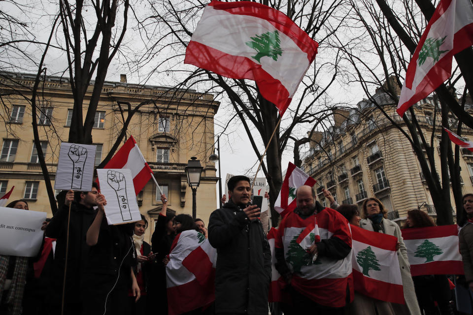 Lebanese protesters gather outside of the French foreign ministry in Paris, Wednesday, Dec. 11, 2019, to denounce a closed-door meeting of diplomats from several countries on aid to Lebanon. The Middle Eastern country is facing a political and economic crisis, and the international group is discussing conditions for global assistance to help ease Lebanon's financial woes.(AP Photo/Francois Mori)