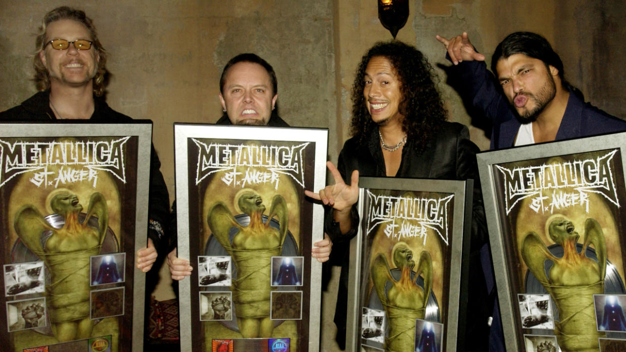  Metallica in 2003 holding St Anger plaques  