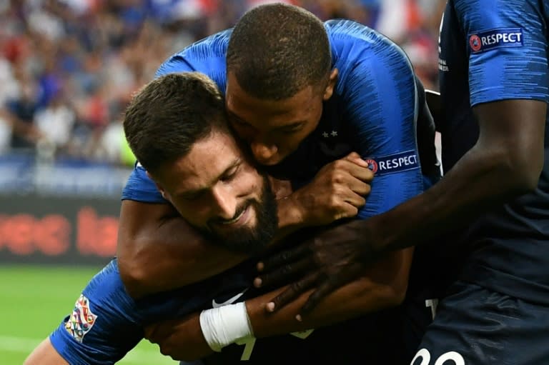 Olivier Giroud is congratulated by Kylian Mbappe after scoring France's winner