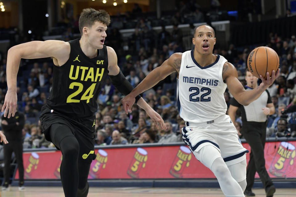 Memphis Grizzlies guard Desmond Bane (22) drives against Utah Jazz center Walker Kessler (24) in the second half of an NBA basketball game Wednesday, Nov. 29, 2023, in Memphis, Tenn. (AP Photo/Brandon Dill)