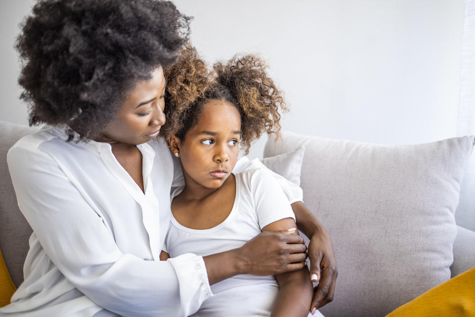 Loving mother consoling or trying make peace with insulted upset stubborn kid daughter avoiding talk, sad sulky resentful girl pouting ignoring caring mom embracing showing support to offended child