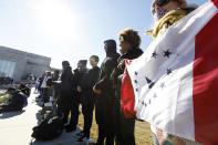 <p>Mississippi flag demonstrators stand along a ledge at Energy Plaza where the state’s bicentennial celebration and the grand opening ceremony for two museums, the Museum of Mississippi History and the Mississippi Civil Rights Museum, was held, Saturday, Dec. 9, 2017, in Jackson, Miss. The protesters are seeking the removal of the Confederate battle flag emblem from the flag and support a different symbol entirely. (Photo: Rogelio V. Solis/AP) </p>