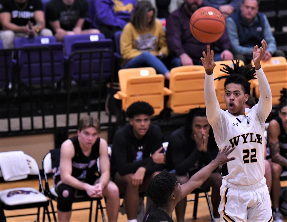 Wylie's Kazion Brown, right, shoots a 3-point goal over a Lubbock Monterey defender in the first half.