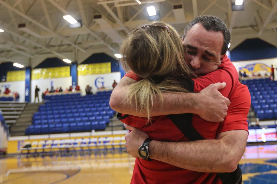 Shallowater's head girls basketball coach Kurt Richardson embraces his wife, Jessica, after Shallowater defeats Jim Ned 43-37 in the Region I-3A final girls basketball game, Saturday, Feb. 24, 2024, at the Tiger Pit in Wolfforth.