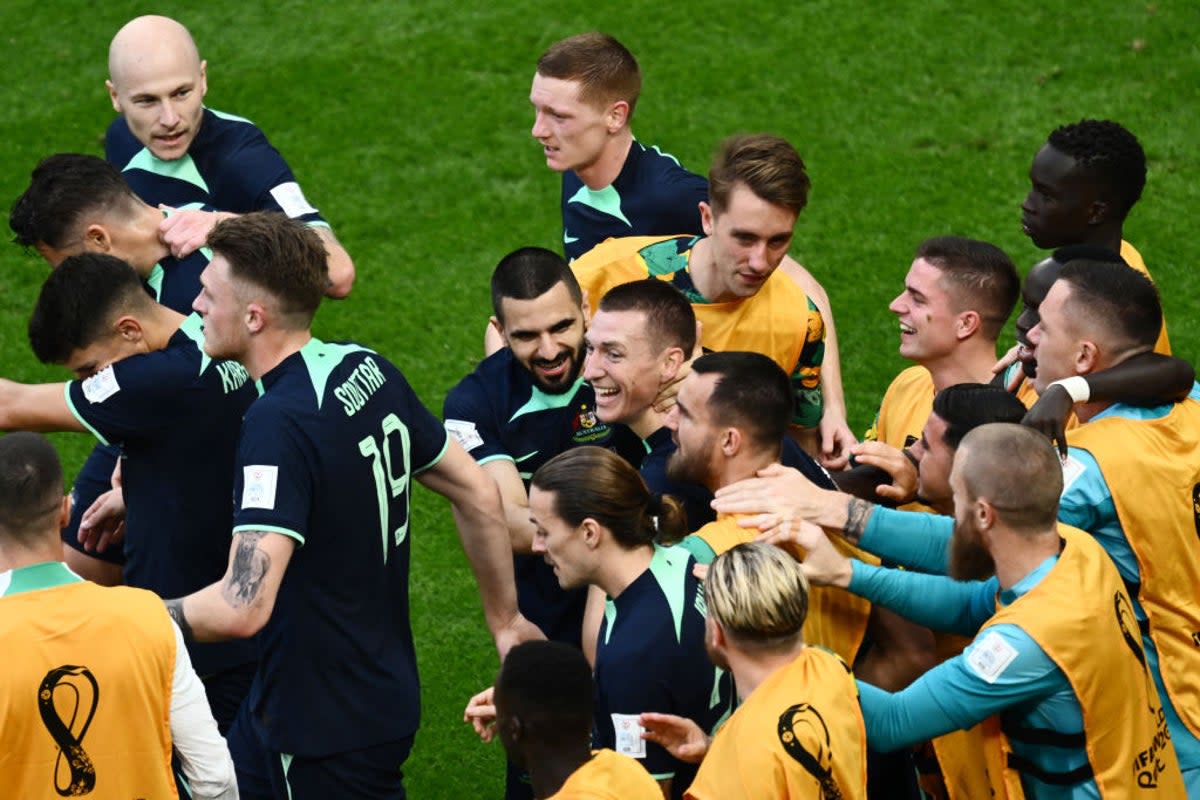 Australia's Mitchell Duke, centre, celebrates with teammates after scoring his team's first goal at Qatar  (AFP/Getty)