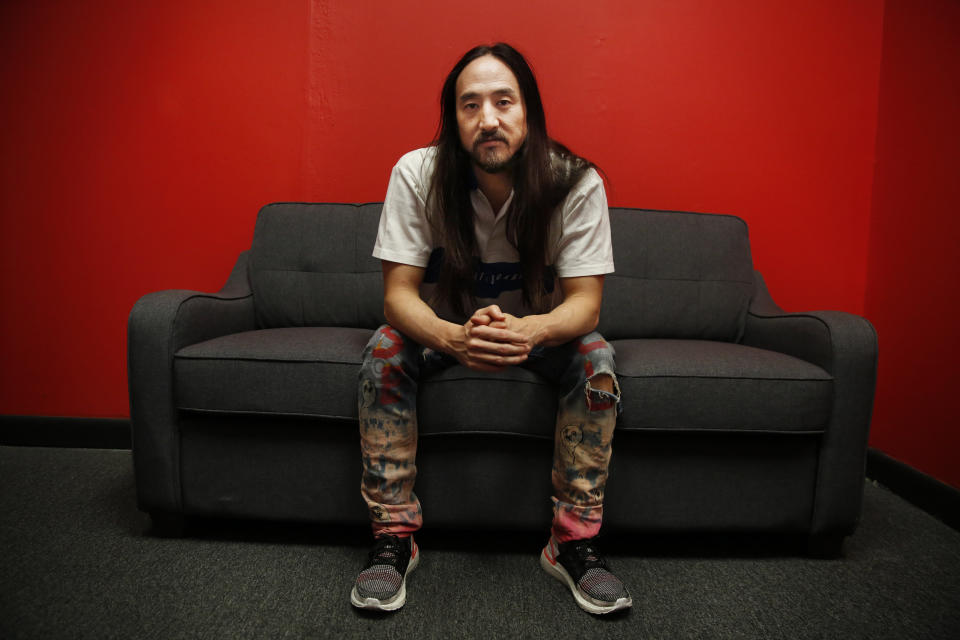 Steve Aoki sits for a portrait during a comic book signing of his new comic book series "Neon Future" at Multiverse Corps. Comics on Thursday, May 2, 2019, in Miami. (AP Photo/Brynn Anderson)