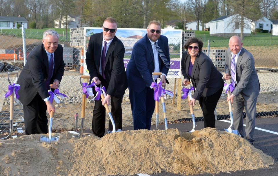 Triway Local school board member Donald Noble, left to right, Superintendent Nate Schindewolf and board members Ryan Gilbert, Anjanette James and Travis Snyder ceremoniously break ground for the new Triway High School and campus on April 20.